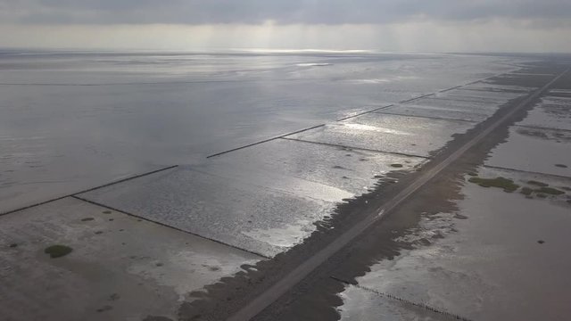 Aerial of Low tide path to the island Mand&oslash; in Denmark, only access by car &ndash; 4K