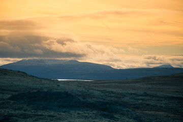 Fototapeta premium A beautiful mountain landscape with a lake in the distance. Autumn mountains in Norway. Fall scenery in Scandinavia.