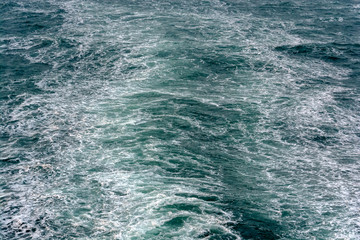 Foamy wake behind the stern of the ship