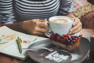 Young woman sitting indoor in urban cafe