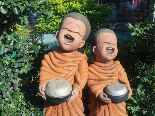 Two happy monks asking for a donation