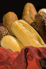 Variety of fresh baked wheat and rye bread, baguette and buns