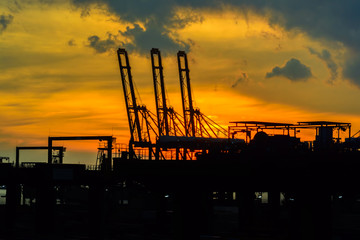 Container terminal of commercial industrial port at sunset.
