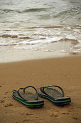 Fototapeta na wymiar flip flops on the seashore