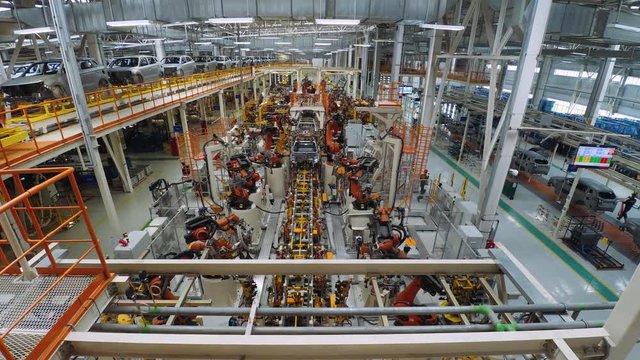 Automobile plant, modern production of cars, car body assembly process, automated production line. Timelapse.

