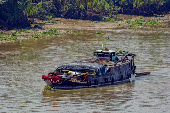 An old wooden cargo vessel anchored in the Soai Rap river