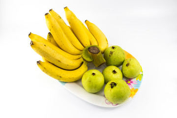 Yellow banana with green guava in long dish