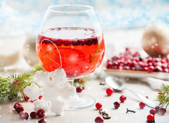 Christmas still life with cranberriy punch and blurred snow outside the window. Festive and bright