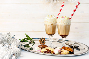 Cappuccino in two long glasses with straws