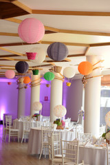 Beautiful colored paper lanterns hanging on the ceiling as air balloons