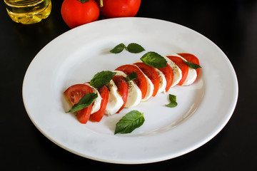 salad with tomatoes and mozzarella on white plate