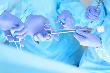 Close-up of unknown surgeons at work while operating at hospital. Health care and veterinary concept