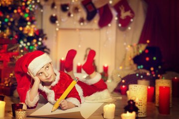 Child Writing Christmas Letter, Happy Kid Write Wish List to Santa in Decorated Xmas Home Room