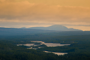 A beautiful lake in the mountain valley. View from above. Colorful autumn landscape in central Norway.