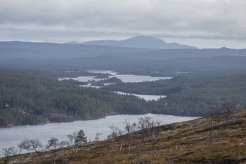 A beautiful lake in the mountain valley. View from above. Colorful autumn landscape in central Norway.