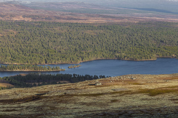 Obraz premium A beautiful lake in the mountain valley. View from above. Colorful autumn landscape in central Norway.