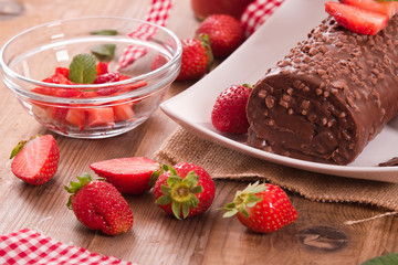 Chocolate roll with hazelnuts and strawberries. 