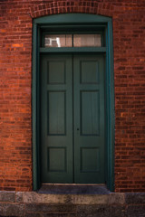 Fototapeta na wymiar Green Door on Red Bricks