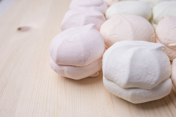 Multicolored marshmallow on a wooden background