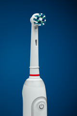 electric toothbrush on blue background