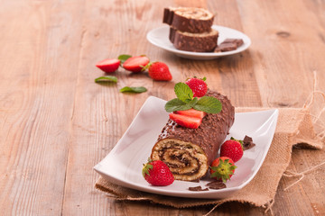 Chocolate roll with hazelnuts and strawberries. 