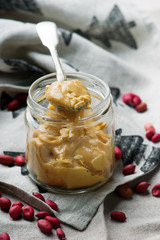 Peanut butter in to the glass jar. selective focus