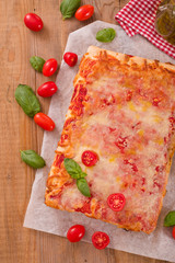 Italian pizza with cheese, tomatoes and fresh basil. 
