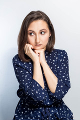 Emotional portrait of a gorgeous young brunette girl. attractive asian woman thinking, sad on white background