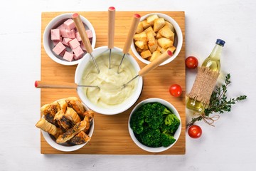 Cold snacks. Sausage, cheese, broccoli and salty sticks. Italian cuisine.On a wooden surface. Top view. Free space for your text.