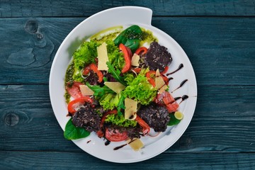 Beef Salad and Fresh Vegetables. On a wooden surface. Top view. Free space for your text.
