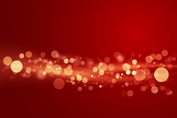 Abstract shiny color gold light wave design element with glitter bokeh effect on dark red background.