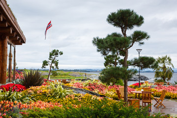 Open air cafe in the garden on a shore of island in Norway, rainy weather