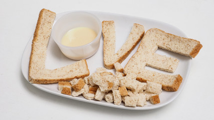 Fototapeta na wymiar Love breakfast create idea from whole wheat bread serve with sweetened condensed milk