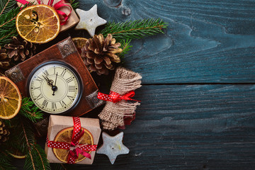 Clock. Christmas wooden background. New Year's holiday. Christmas motive. On a wooden surface. Top view. Free space for your text.