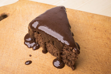 Chocolate cake on a wooden cutting board
