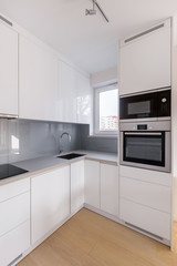 Fototapeta premium White kitchen with gray tiles