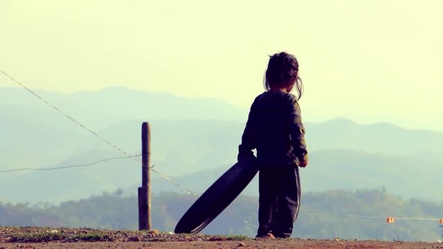Indian poor village girl playing with tire