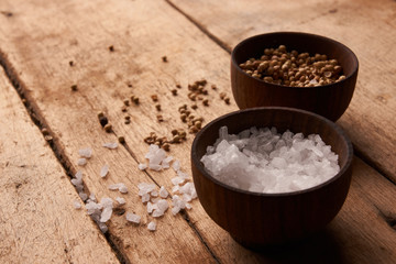 Peppercorns and sea salt in a wooden bowl