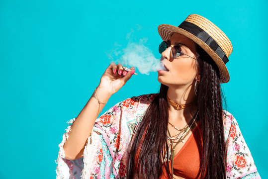 girl smoking cigarette and exhaling smoke