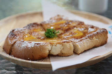 French toast with icing and honey on top.