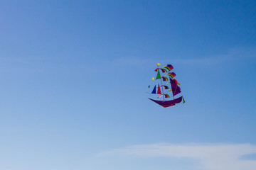Colorful flying boat on the blue sky background