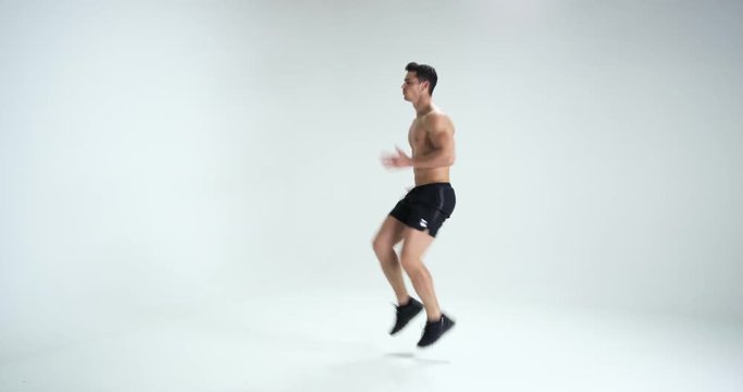 Muscular man warming up against white background. RED EPIC. 4k