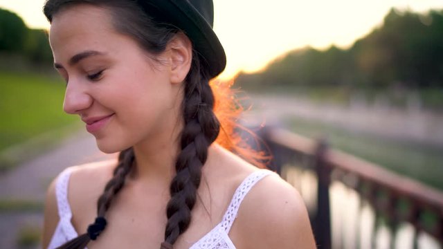 Portrait of young smiling girl in fashion hat outdoors