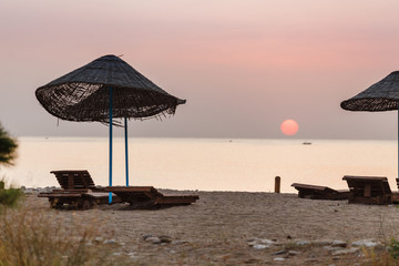 A parasol silhouette at early morning at sunrise on the beach