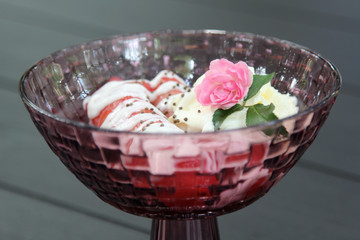 Pink rose decorated on preserved banana with syrup, coconut milk and whip cream.