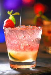 Red drink with strawberry mint leaves