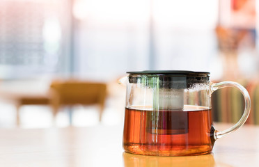 tea pot on a wooden table in a Cafe close-up with copy space