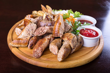 Assorted sausages with sauce