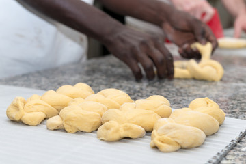Obraz na płótnie Canvas baker prepares bread dough in his bakehouse