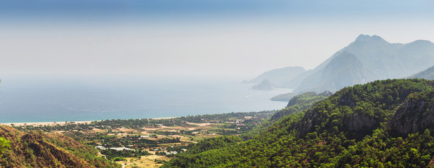Aerial panoramic view of one of the most beautiful beaches in the world and Turkey - Cirali or Chirali near Antalya, surrounded by majestic mountains and the Mediterranean Sea
